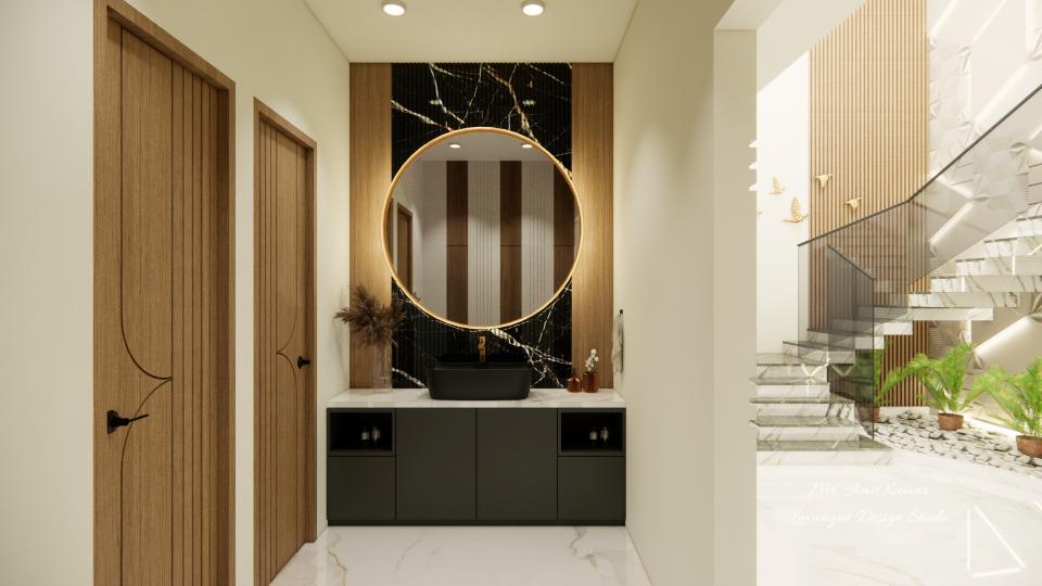 Black vessel washbasin on a white countertop with dark grey cabinets against a black marble accent wall with a large circular backlit mirror, and two wooden textured doors with grooves to the left.