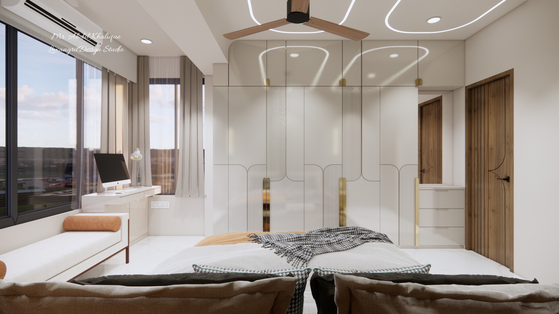 White full-wall wardrobe with groove-cut arch panel detailing, brass handles, loft storage, and side dressing unit in a modern master bedroom