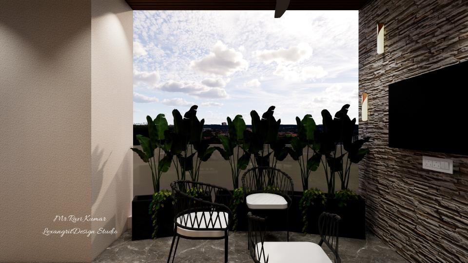 Balcony view with a modern seating area featuring three black wire chairs with white cushions around a small coffee table, overlooking a parapet wall and planter box with tropical plants, and a textured stone stacked accent wall with a wall-mounted TV and two vertical light fixtures on the right.