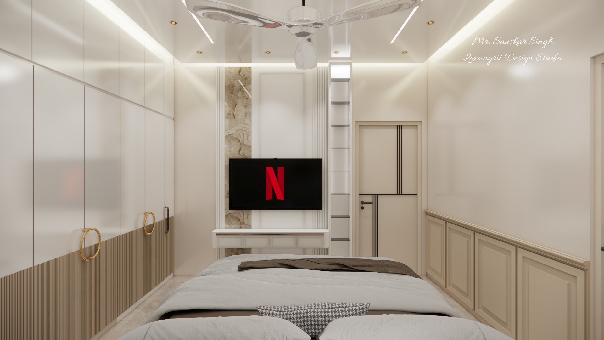 Bedroom viewed from the bed toward a television niche, with full-height wardrobes, paneled lower cabinets, ceiling fan, and bright cove lighting.