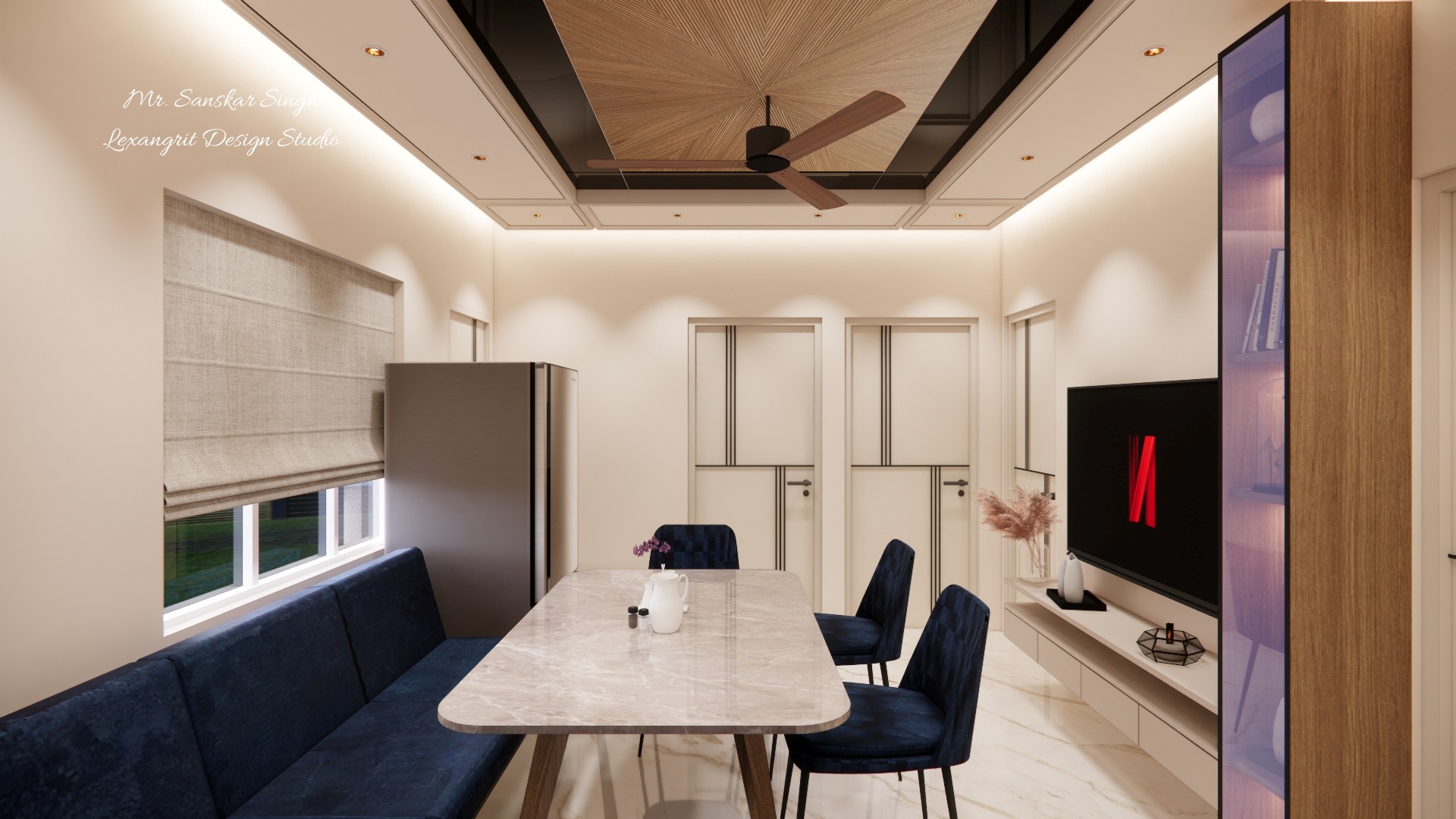 Combined dining and media area with a navy banquette, marble table, window blind, refrigerator, television wall, and a geometric ceiling fan feature.