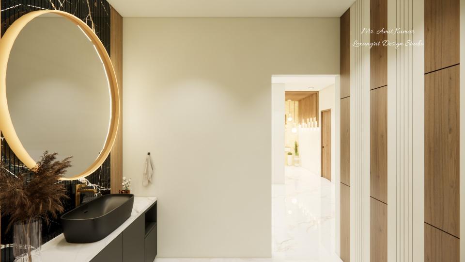 Handwash area with a black vessel sink and large gold-framed circular mirror, minimalist cream wall, wood-and-white striped accent wall on the right, and a doorway to a bright corridor with marble flooring.