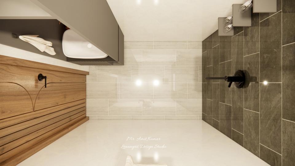 Top view of a powder bathroom with beige textured tiles, a dark grey accent wall with matte black shower fixture, and a white sink in the corner with warm lighting.