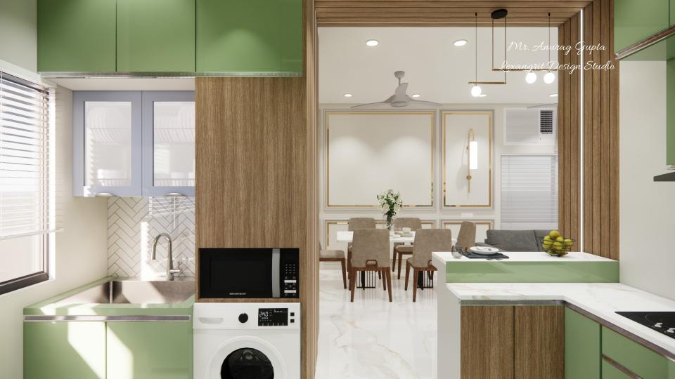 A modular kitchen featuring green lower cabinets, a stainless steel sink, a tall wood-grain unit housing a built-in microwave and a laundry front-loading washing machine, with a view into a dining room through a wooden-framed doorway.