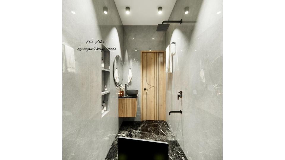 Image of the bathroom showcasing a spacious shower area with a sleek vanity  and modern fixtures against a tiled wall
