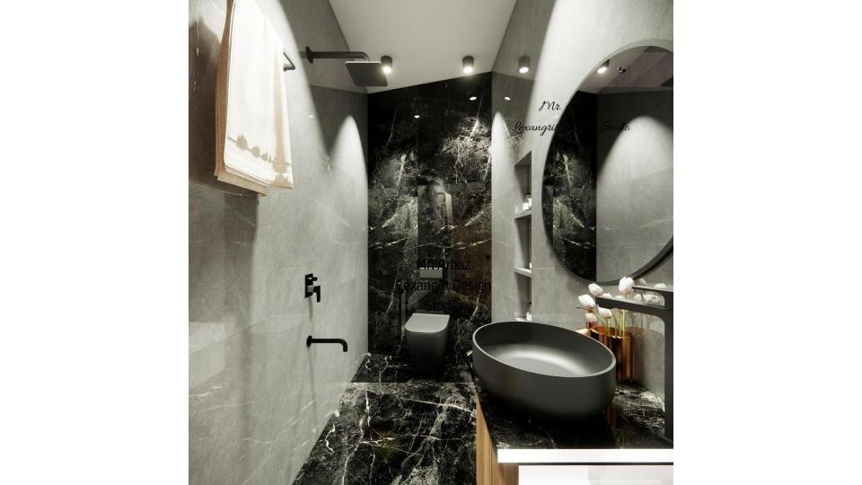 Image of the bathroom showcasing a spacious shower area with a some storage  and modern fixtures against a tiled wall