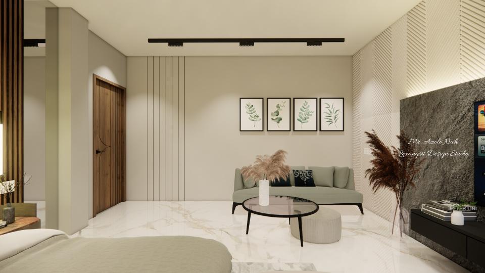 Image of the master bedroom displaying a comfortable seating area with a chaise lounge, side table, and a lamp against a decorated wall