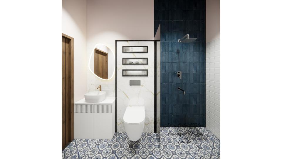 Image of the bathroom showcasing a spacious shower area with a glass partition and modern fixtures against a tiled wall