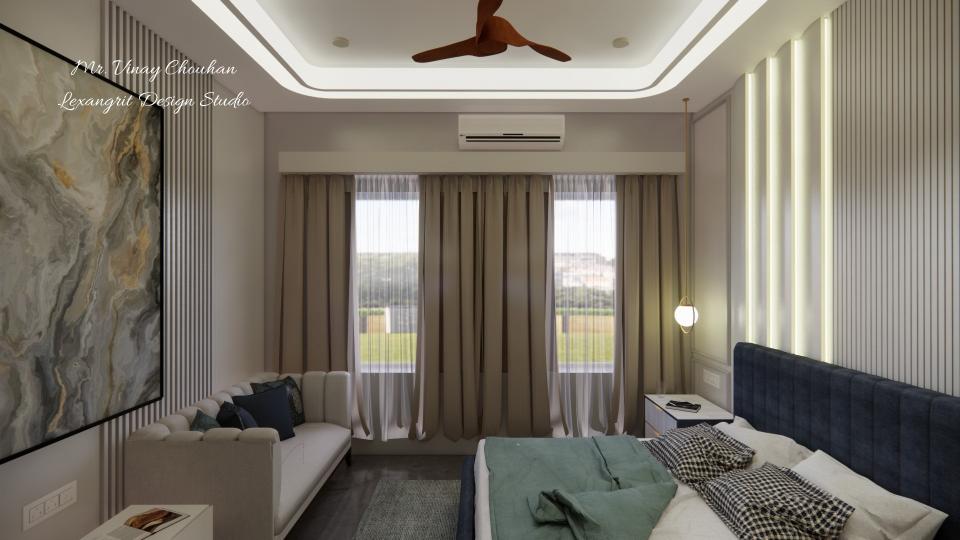 Image of the master bedroom displaying a comfortable seating area with a chaise lounge, side table, and a lamp against a decorated wall