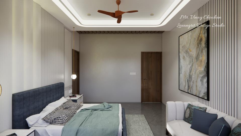 Image of the master bedroom displaying a comfortable seating area with a chaise lounge, side table, and a lamp against a decorated wall