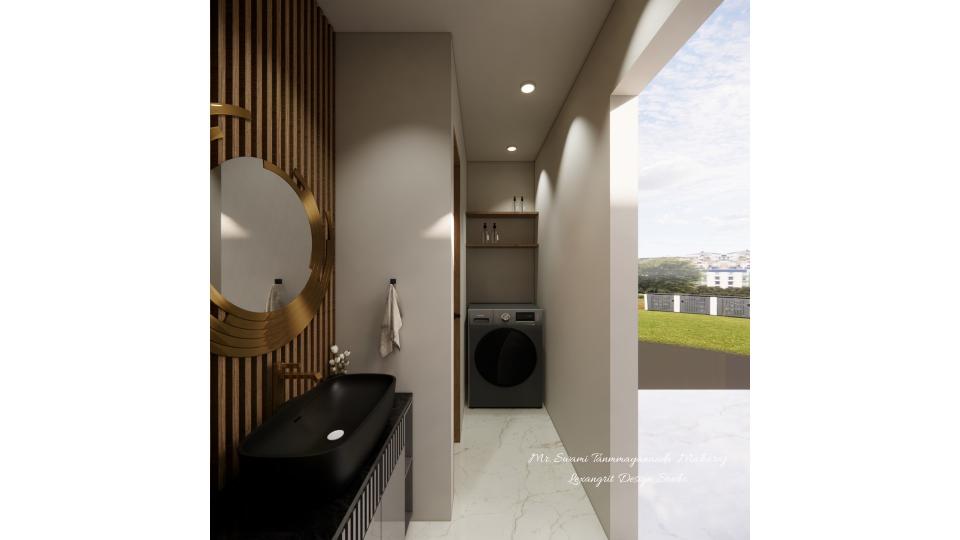 A narrow balcony corridor featuring a black vanity sink against a vertical wood slat wall with a round gold mirror, leading to a dark grey front-loading washing machine or laundry with open shelving above, and an open doorway behind the room revealing a green lawn and distant buildings.