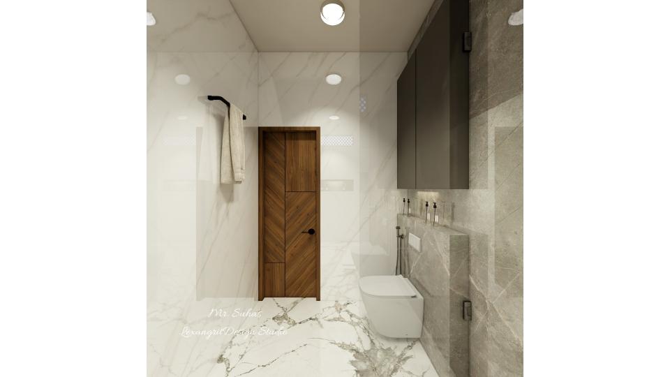 In this image we can see the door is designed with wooden laminate with Zig-Zag design and storage above Wc is designed with grey matte laminate finish ,towel hanger is placed beside door wall .