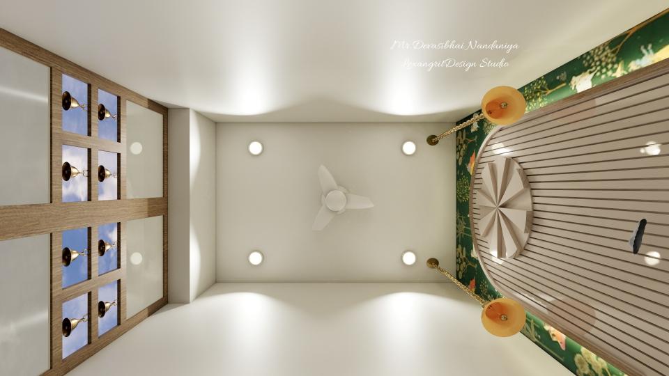 In this image we can see the ceiling,small fan is placed at the centre & bells are hung above the idol with ceiling lights accordingly.