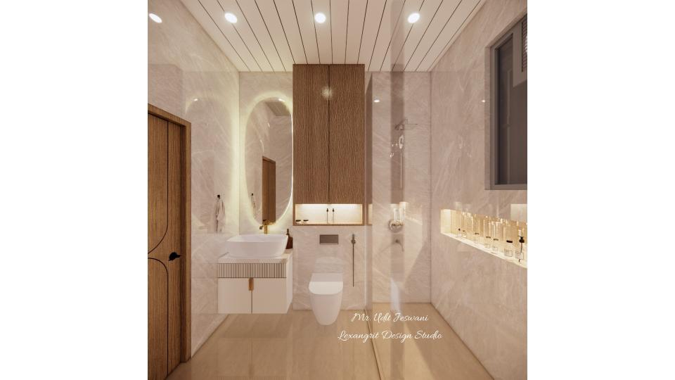 Counter top wash basin with vanity unit of wpc with combination of fluted and glossy laminate with brass linear handle with full oval mirror,wall mounted Wc with storage on the top with WPC with wooden laminate finish,shower area at the corner with glass partition.